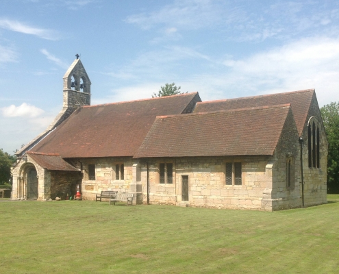 St Helens Church Bilton in Ainsty on a sunny day with blue skies