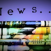 Composit image of several newspapers on a purple background